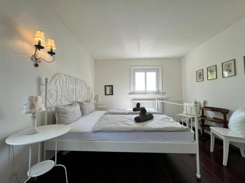 a bedroom with a bed with a teddy bear on it at Landhaus am See mit privatem Seezugang in Meersburg