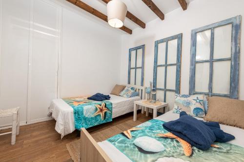 two beds in a room with windows at Beachfront two bedrooms house Casa Toral in Majanicho