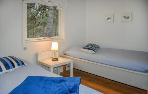 a room with two beds and a window at Awesome Home In Yngsj With House A Panoramic View in Yngsjö