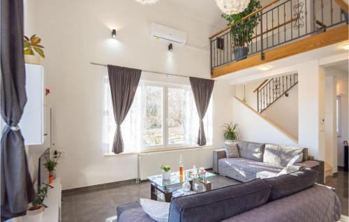 a living room with a couch and a table at Gorgeous Home In Neoric With Kitchen in Neorić