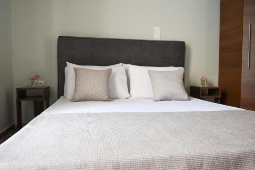 a large bed with white sheets and pillows at Anastasia mare home #A# in Rethymno