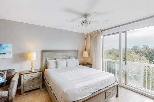 a bedroom with a bed and a large window at Elation #5513 in Destin