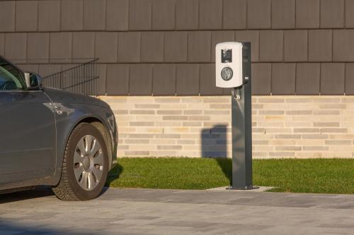 a parking meter with a car parked next to it at Haus Berg-Ahorn in Büsum