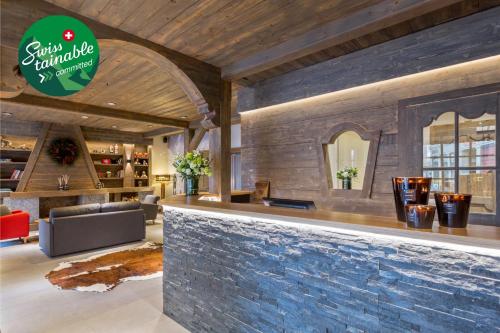 a bar in a restaurant with a stone wall at Edelweiss Manotel in Geneva