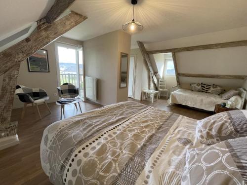 a bedroom with a large bed with a large window at Chez evelyne et titou in Bordères