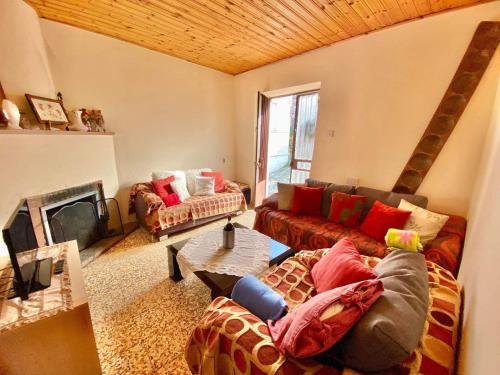 a living room with a couch and a fireplace at Saint Nicholas heights in Chakistra