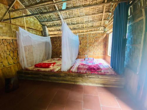 a bed in a room with nets on it at Pù luông homestay Ngọc Dậu in Thanh Hóa