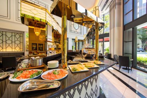 a buffet line with plates of food at KOKO HOTEL Premier Nihonbashi Hamacho in Tokyo