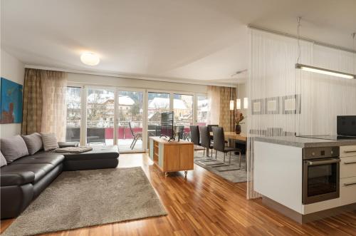 a living room with a couch and a table at Appartementhaus Crystal by Schladming-Appartements in Schladming