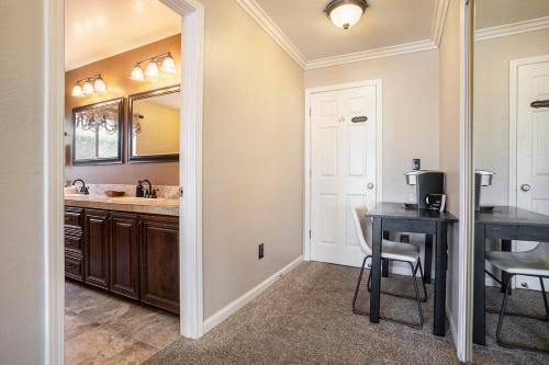 a kitchen with a sink and a table and a mirror at Lakefront Gem: Private Dock in Discovery Bay