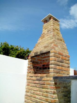 a brick chimney sitting on top of a house at Privê dos Carneiros in Tamandaré