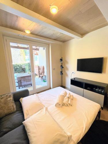 a bedroom with a bed with two towels on it at Le Petit Chalet Limone in Limone Piemonte