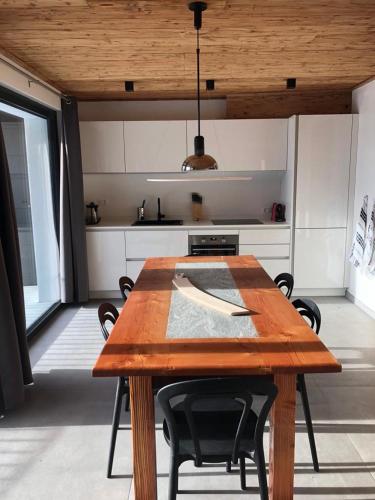 a kitchen with a wooden table and chairs in a room at Casa Lo Tzé Relais - Indipendent house with amazing view in Valtournenche