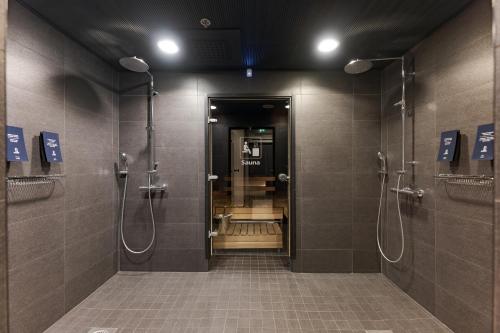 a bathroom with a walk in shower with stalls at Solo Sokos Hotel Torni Tampere in Tampere