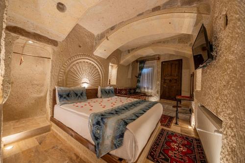 a bedroom with a large bed in a building at FARMER CAVE HOUSE in Urgup