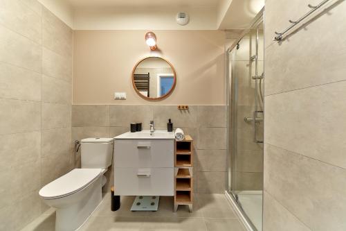 a bathroom with a toilet and a sink and a shower at Mountain Gem Zakopane in Zakopane