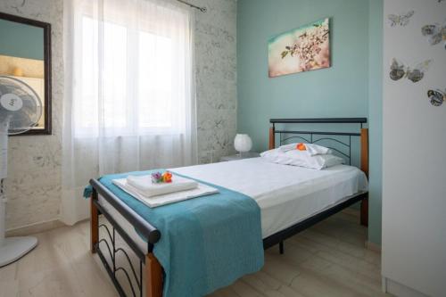 a bedroom with a bed with a tray on it at Marilis House, private swimming pool, south beach, mountain view in Árdhaktos