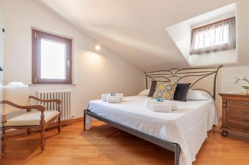 ein Schlafzimmer mit einem Bett und einem Stuhl in der Unterkunft Italian Experience- AltoMare Apartment in Porto SantʼElpidio