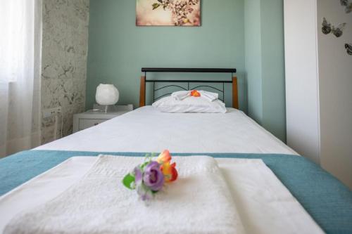 a bed with two toys sitting on top of it at Marilis House, private pool, WIFI, mountain view, Netflix, self-check-in in Ardaktos