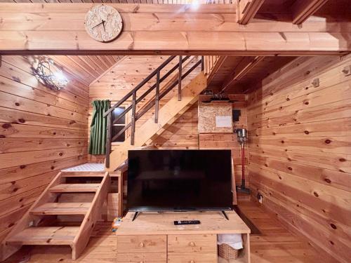 a living room with a large tv in a cabin at Aki in Hakuba