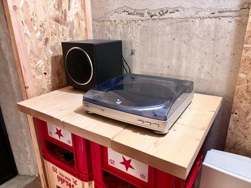 a router sitting on a wooden table with a speaker at Aki in Hakuba