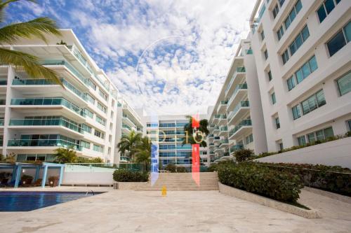 um grande edifício de apartamentos com uma estátua em frente em Condominio frente al mar con acceso directo a la playa Morros 922 em Cartagena das Índias