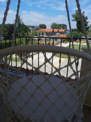 a hammock with a view of a playground at Makis Nest Apart-Hotel in Vourvourou