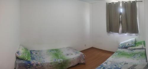 a living room with a couch and a window at Apartamento Super Aconchegante em Ambiente Familiar in Contagem
