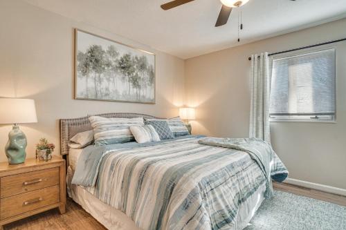 a bedroom with a bed and a ceiling fan at Bright Helen Cottage Walk to Town! in Helen