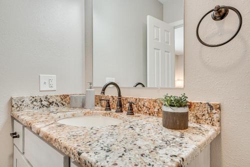 a bathroom counter with a sink and a mirror at Bright Helen Cottage Walk to Town! in Helen