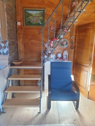a staircase in a room with a blue chair at Eko kuća Zlatiborsko srce in Zlatibor