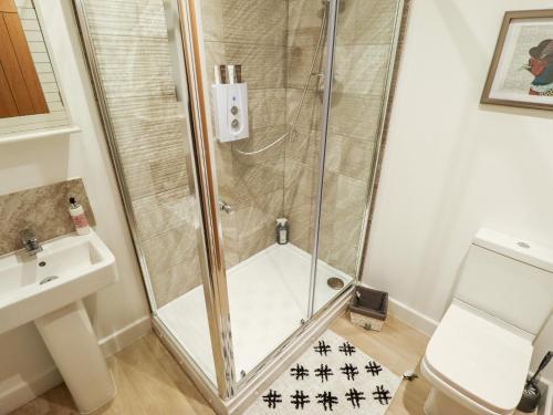 a shower with a glass door in a bathroom at The Nest in Doncaster