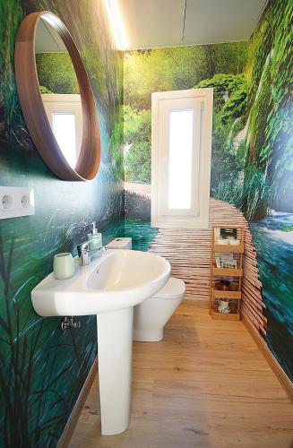 a bathroom with a sink and a mirror at GALIHOST - A Casa do Olivo in Meis