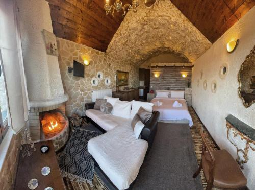 a room with two beds and a fireplace in it at Anilia Guesthouse in Synikia Mesi Trikalon