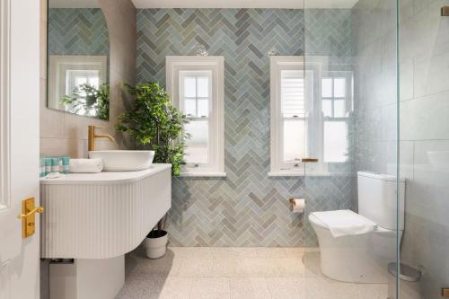 a bathroom with a sink and a toilet at Stunning Terraced Apartment near the Sydney Opera House in Sydney