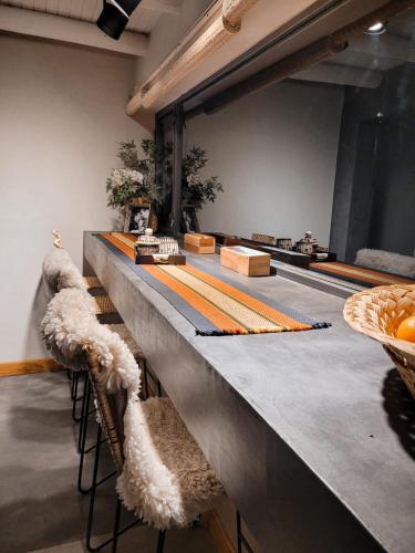 a long counter with a long table with chairs at Finca La Saucina Casa de Campo in Tunuyán