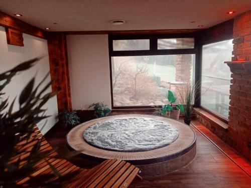 a large room with a large window and a large round bath tub at Hotel Styl Hlinsko in Hlinsko