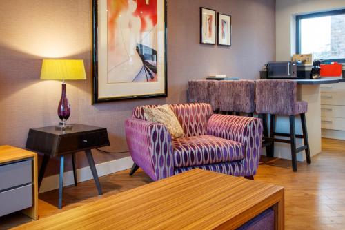 a living room with two chairs and a table at The Boat House Apartment by Cliftonvalley Apartments in Bristol
