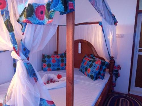 a bedroom with a bunk bed with a canopy at Jambo Kendwa Villa in Kendwa