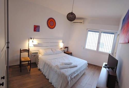 a bedroom with a bed with two towels on it at Seaside Villa with Hot Tub, 5mins walk from the sea in Torre rinalda
