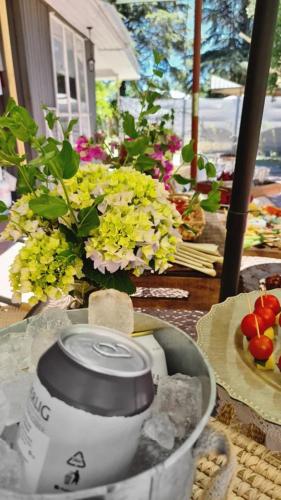 a table with a bowl of food and flowers at Agradable casa con Tina de agua Caliente y Piscina in Quillón