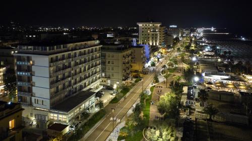 a view of a city at night with street lights at Hotel Centrale Miramare in Rimini