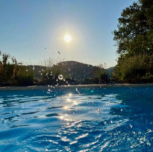 a large body of water with the sun in the background at La Parenthèse du Var - Chambre d'hôtes petits déjeuners inclus et terrasse ombragée in Saint Antonin du Var