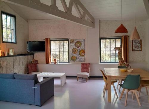 a living room with a couch and a table at Holiday Loft 58 in Arbois