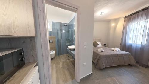 a bedroom with a bed and a bathroom with a shower at Sidus Condos in Veria
