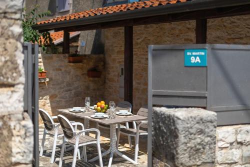a table with chairs and a sign on top of it at Rustic villa Casa Tessa with outdoor pool in Tar in Tar