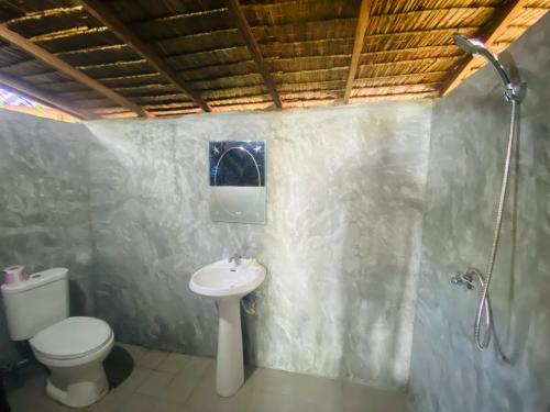 a bathroom with a toilet and a sink at Banana Resort in Ko Phayam