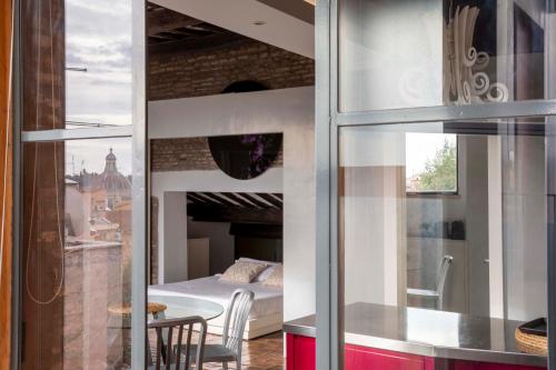 a room with a bed and a table and a window at Monti apartment BDB in Rome