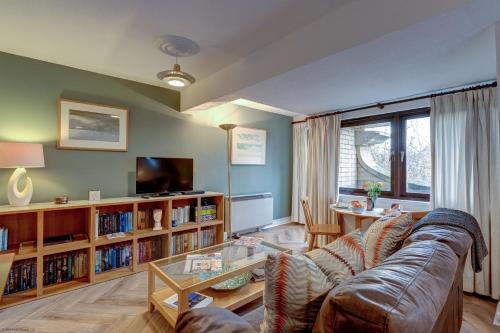 a living room with a couch and a table at Spires View in Oxford