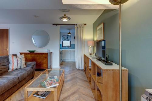 a living room with a couch and a table at Spires View in Oxford